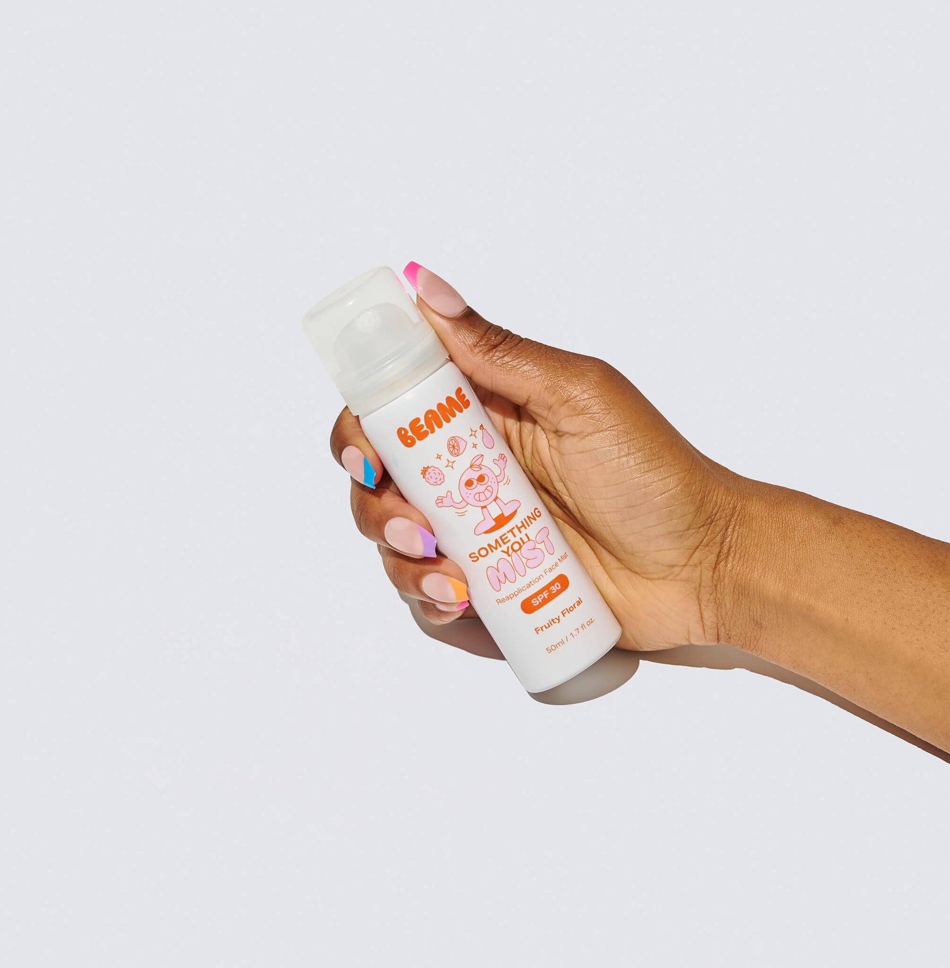 Hand holding a BEAME bottle with a white background